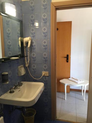 a bathroom with a sink and a toilet at Hotel Sestriere in Chianciano Terme