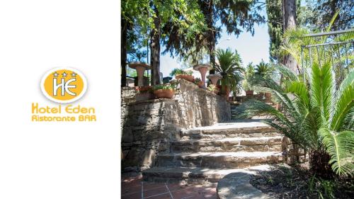 a set of stone steps in a garden with palm trees at Hotel Eden in Perdifumo
