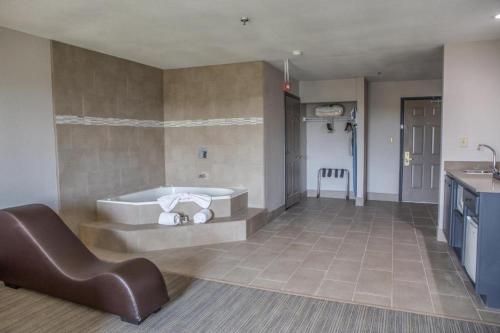a large bathroom with a tub and a sink at Country Inn & Suites by Radisson, Harlingen, TX in Harlingen