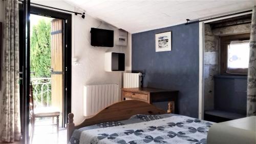 une chambre avec un lit et un mur bleu dans l'établissement Gites du Mas Gibert à SAUSSINES entre Nimes et Montpellier, à Saussines