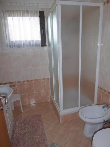 a bathroom with a shower and a toilet and a sink at APARTMA PANORAMA in Kobarid
