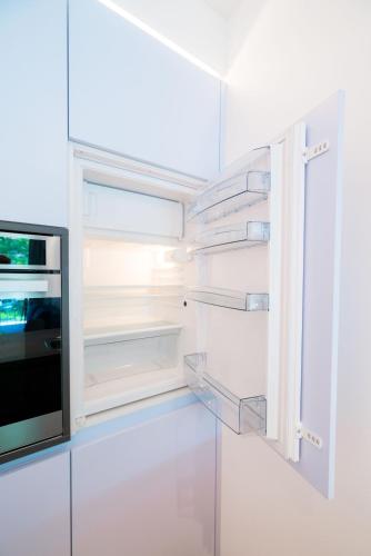 an empty refrigerator with a window in a kitchen at Vienna Residence, Hietzing - Schönbrunn in Vienna