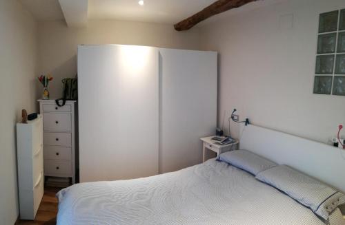 a bedroom with a bed and a white wall at La casa di Gigioz in Sestri Levante