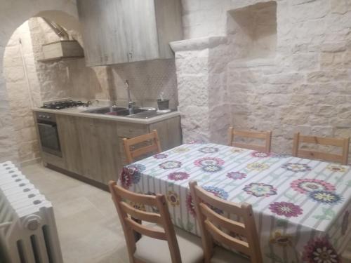 a kitchen with a table with a table cloth on it at Trulli Manuela 1 in Locorotondo