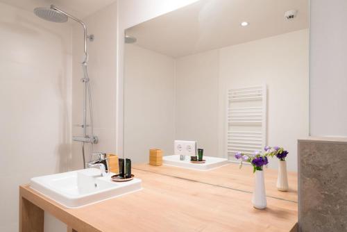 a bathroom with two sinks and a mirror at Vienna Residence, Hietzing - Schönbrunn in Vienna