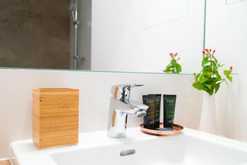a bathroom sink with a faucet and a mirror at Vienna Residence, Hietzing - Schönbrunn in Vienna