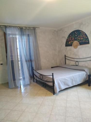 a bedroom with two beds and a window at b&b Casa Regina in Stroncone