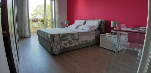 una camera con letto e parete rosa di Casa RA a Torino