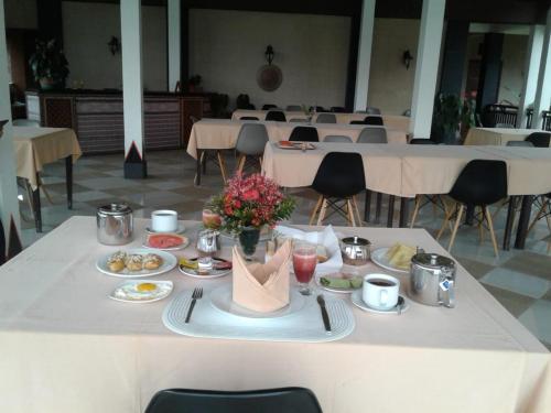 a table with plates of food on top of it at Toraja Torsina Hotel in Rantepao
