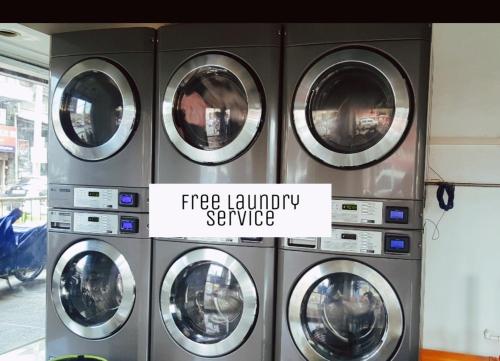 a group of four washing machines in a laundromat at CHE & JAMES FEMALE GUEST House COLON, CEBU in Cebu City