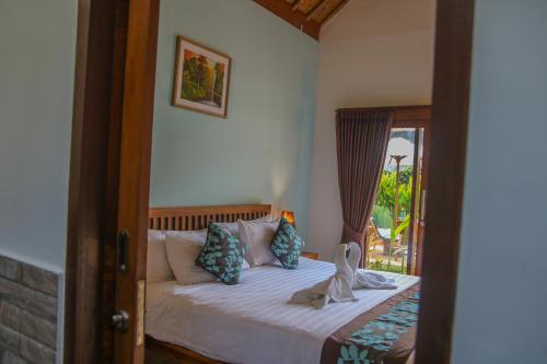 Ένα ή περισσότερα κρεβάτια σε δωμάτιο στο Cozy Cottages Lombok