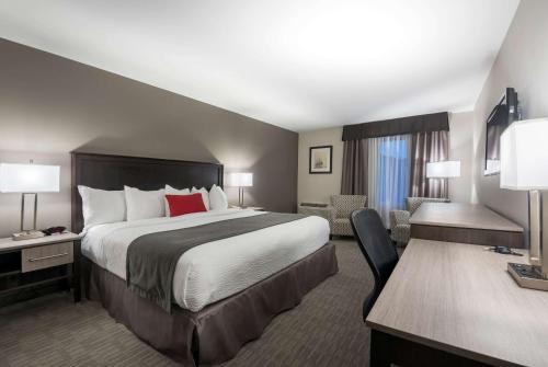 a hotel room with a large bed and a desk at Chateau Bedford Trademark Collection by Wyndham in Halifax