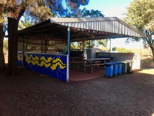 a food stand with a tent on the ground at Tom Price Tourist Park in Tom Price