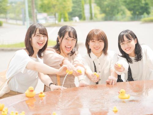 a group of women standing around a table with rubber ducks at Hotel Areaone Hiroshima Wing in Higashihiroshima
