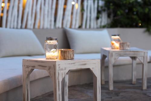 a couple of tables with candles on top of them at Kobe Suite Resort in Watamu