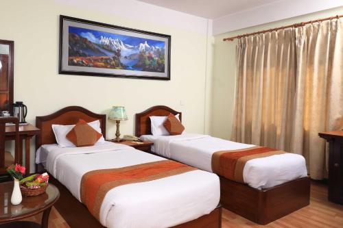 a hotel room with two beds in a room at Samsara Boutique Hotel in Kathmandu