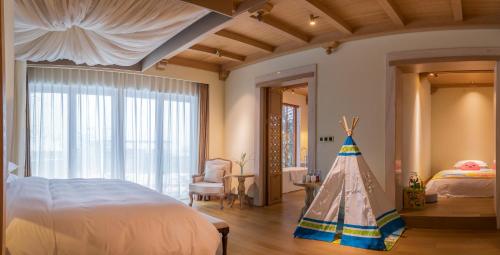 a bedroom with a bed and a large window at Evergreen Retreat-walk to National Forest Park, free pick up service in Zhangjiajie
