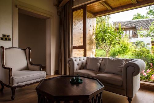a living room with a couch and a coffee table at Evergreen Retreat-walk to National Forest Park, free pick up service in Zhangjiajie