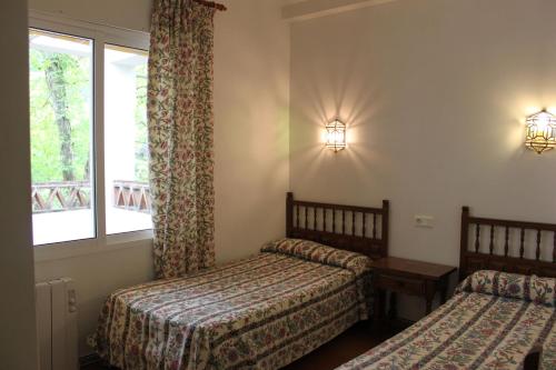 Postel nebo postele na pokoji v ubytování Apartamentos Los Manueles