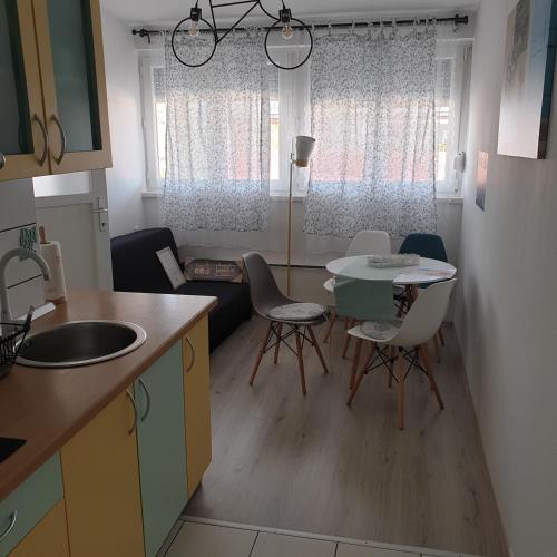 a kitchen and dining room with a table and chairs at Apartman Jež - free parking, self check in in Karlovac