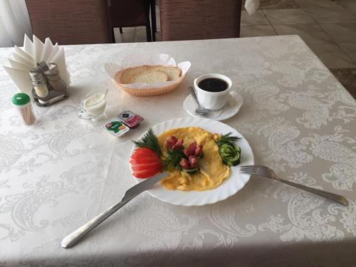 a plate of food on a table with a fork at Hotel Sharm in Khimki