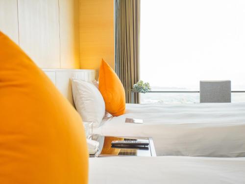 a hotel room with a bed and a window at Freshfields Hotel in Wuri