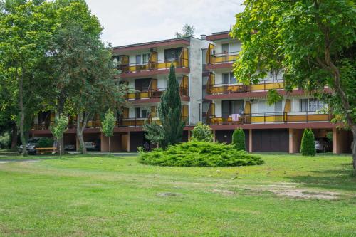 an apartment building with a park in front of it at Helikon 32 Apartman Keszthely in Keszthely