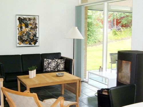 a living room with a couch and a table at 6 person holiday home in Struer-By Traum in Remmer Strand