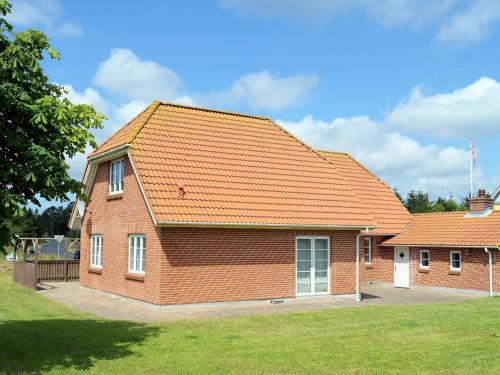 a large brick building with an orange roof at 14 person holiday home in Bl vand in Ho