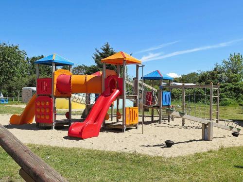 a playground with a slide in a park at 6 person holiday home in Struer-By Traum in Remmer Strand