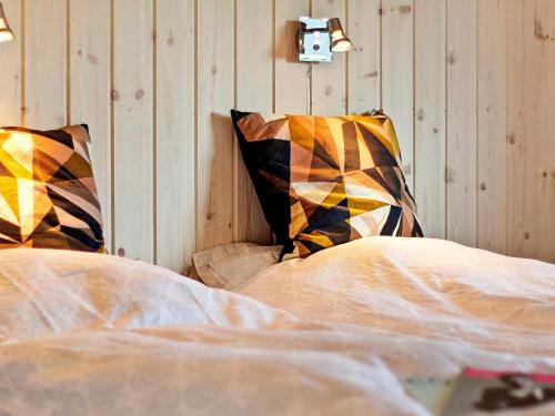 a bedroom with a bed and two pillows at Luxury Retreat by Skastrup - By Traum Ferienwohnungen in Bogense