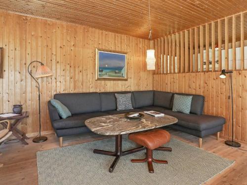 a living room with a couch and a table at 6 person holiday home in Saltum in Saltum