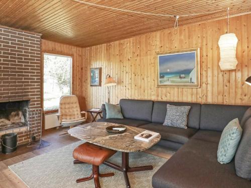 a living room with a couch and a table at 6 person holiday home in Saltum in Saltum