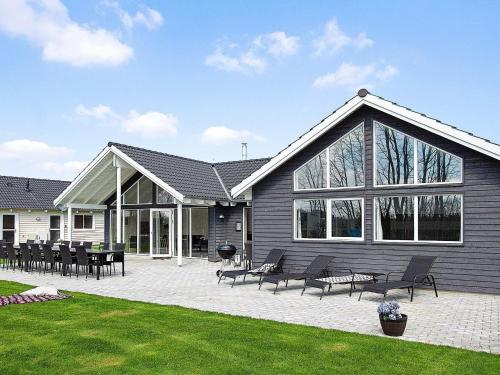 a house with a patio with tables and chairs at 16 person holiday home in Hasselberg in Kappeln