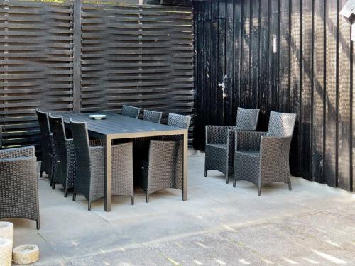 uma mesa de madeira e cadeiras num pátio em 6 person holiday home in Hals em Hals