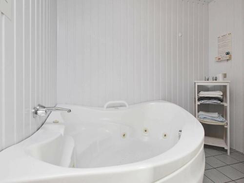 a white bath tub in a white bathroom at 6 person holiday home in Harbo re in Harboør