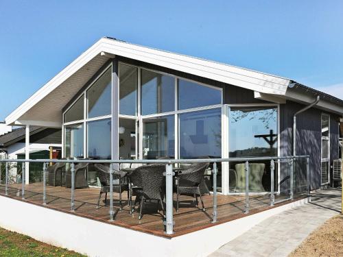 une maison avec des portes en verre et une terrasse dans l'établissement 8 person holiday home in Faaborg, à Bøjden