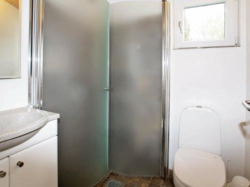 a bathroom with a shower with a toilet and a sink at 6 person holiday home in Tarm in Tarm