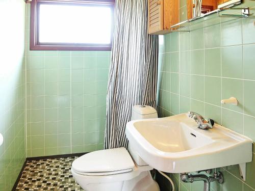 a bathroom with a toilet and a sink at Secluded Haven near Fjord - By Traum Ferienwohnungen in Sønder Nissum