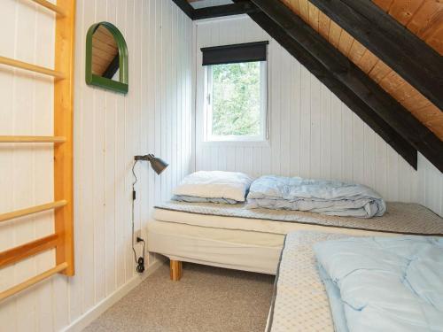 a bedroom with a bed and a window in it at 6 person holiday home in Knebel-By Traum in Skødshoved Strand