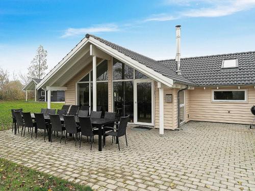 a group of black chairs sitting in front of a house at 12 person holiday home in Hasselberg in Kappeln