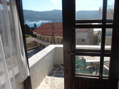 an open door to a balcony with a view at Notis Hotel in Samos