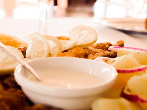 a plate of food with lemon slices on it at Villa Rustica in Gornea