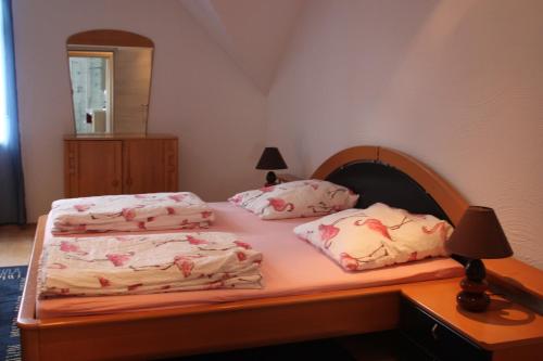 a bedroom with two beds and a mirror at FeWos im alten Bahnhof in Lauterecken