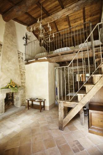 a living room with a staircase and a fireplace at La Locanda Del Ruspante in Castro dei Volsci