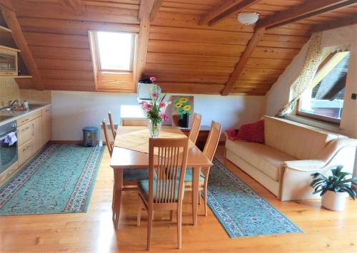 a kitchen and dining room with a table and a couch at Apartment Ana in Ljubno