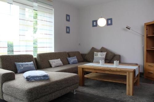 a living room with a couch and a coffee table at Traumhaftes Ferienhaus an der Nordseeküste in Otterndorf