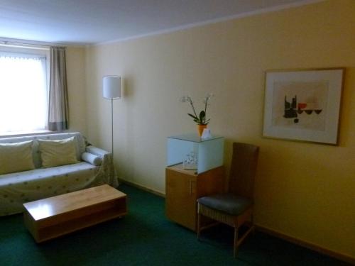 a living room with a couch and a chair at Hotel Markt3 in Bad Honnef am Rhein