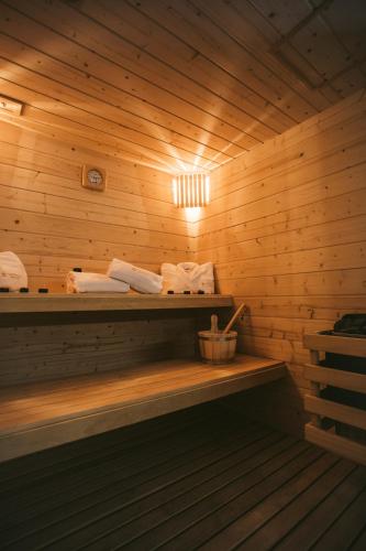 a sauna with wooden walls and a shelf with towels at Castello Prime Suites in Lisbon