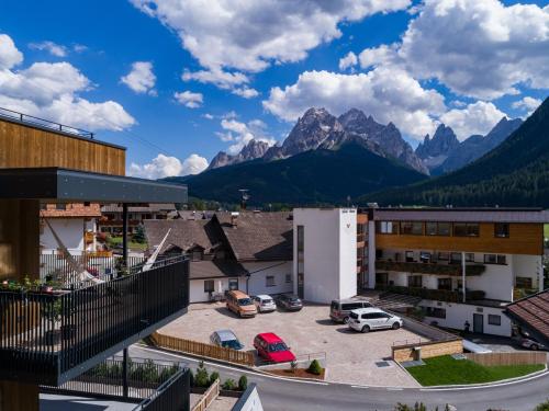 a view of a town with mountains in the background at Alpenwellnesshotel St. Veit in Sesto